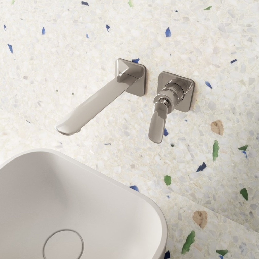 Lifestyle image of the Crosswater Huck Chrome Wall Mounted Basin Mixer installed above a white countertop basin